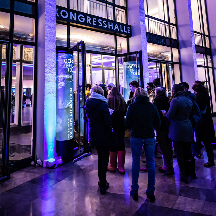 Visitors standing in line outside the Congress Hall for the International Ocean Film Tour.